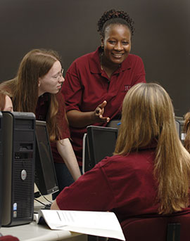Dr. Rose Shumba works with students in Information Assurance.