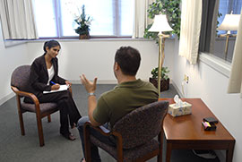 A Psychology graduate student works with a client in a clinical setting. A Psychology graduate student works with a client in a clinical setting.