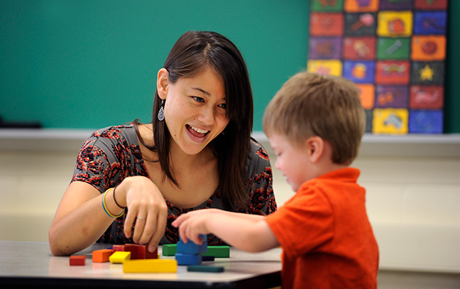 An education student interacts with a child