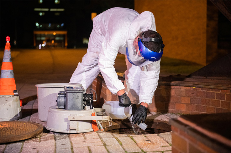 a man taking a water sample