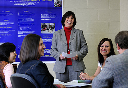 Nursing faculty member talking with students