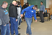 Dr. Lou Pesci instructs a student demonstrating the fatal vision goggles.