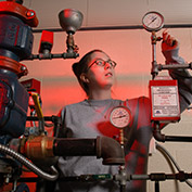 A student checks a gauge