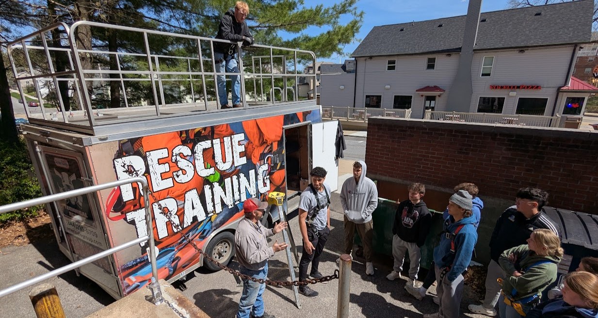 A class is taught outside the Safety Sciences building