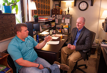 Dr. Mueller with a student in his office