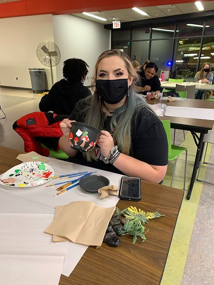 A student makes a craft for self-care day
