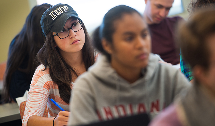 A student takes notes in an Economics class.