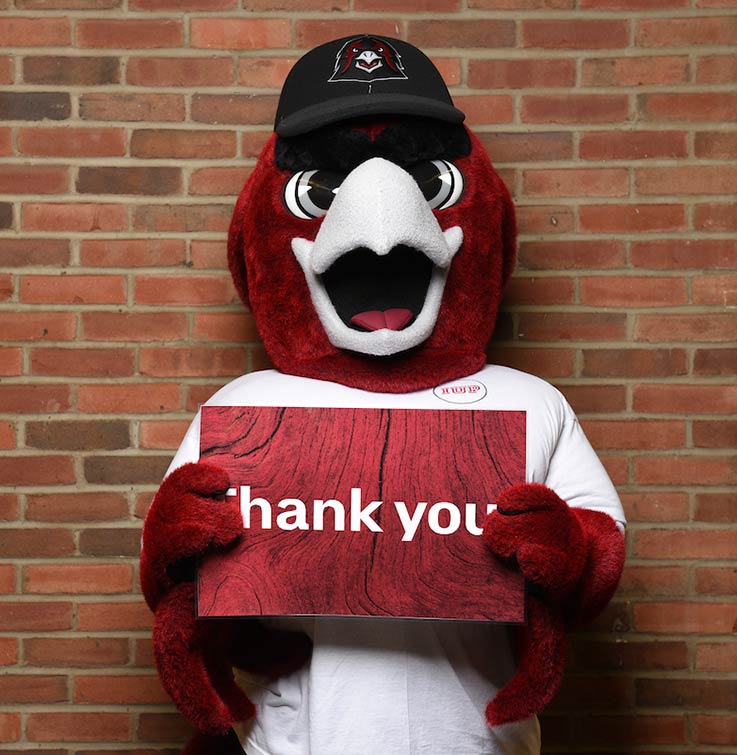 Norm holding a Thank You sign