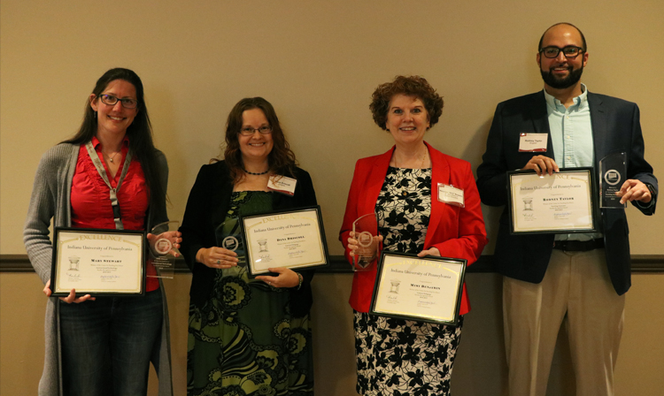 Winners of the Faculty Recognition awards holding plaques