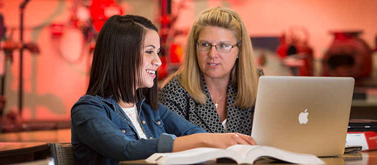 A Safety Sciences professor talks to a student