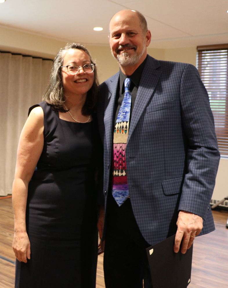 Brian Jones receives the award from Anne Kondo