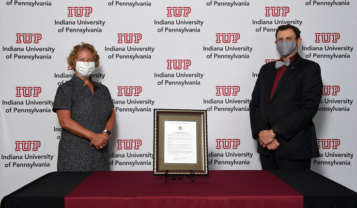Bonnie Anderson and President Driscoll stand with the Resolution plaque Bonnie Anderson and President Driscoll stand with the Resolution plaque