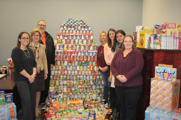 Chelsey Baun, Sylvia Gaiko, Dennis Frketich, Pamela O'Harra, Nicole Buse, Liz Moreno, and Jodie Seybold stand with the collections Chelsey Baun, Sylvia Gaiko, Dennis Frketich, Pamela O'Harra, Nicole Buse, Liz Moreno, and Jodie Seybold stand with the collections