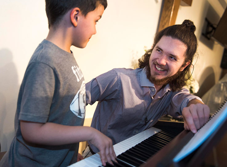 Teryl Rice offers piano lessons to Ark of Learning student Josh Swires Teryl Rice offers piano lessons to Ark of Learning student Josh Swires