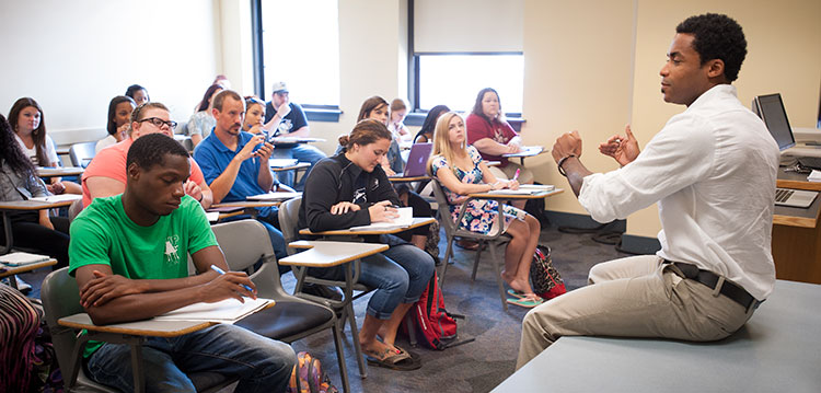 Students take notes during in a Pan-African Studies lecture Students take notes during in a Pan-African Studies lecture