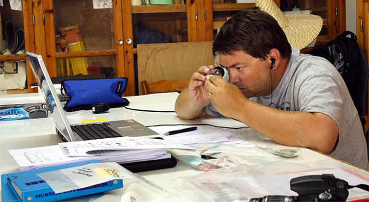 History professor R. Scott Moore studies specimens from his research in Cyprus