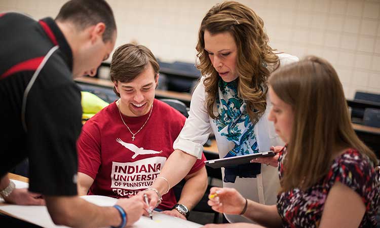 Kinesiology students working with professor