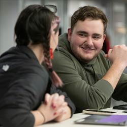 Students sitting together at a desk studying