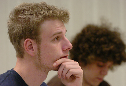 A math student listens in class