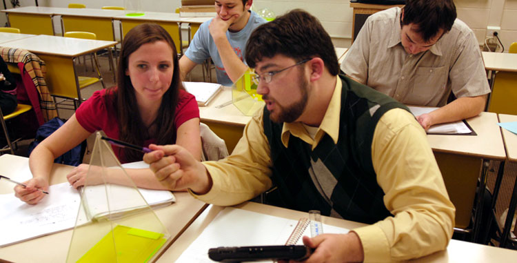 Two math students work together in class