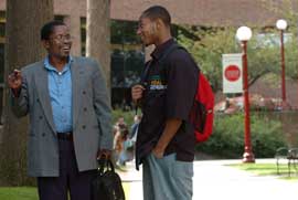 Professor and student talk in the Oak Grove