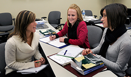 Three graduate students in a meeting