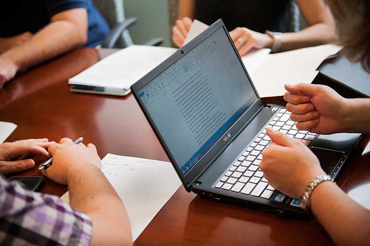 Criminology student working on a computer