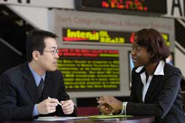 Business students sitting in the Eberly lobby