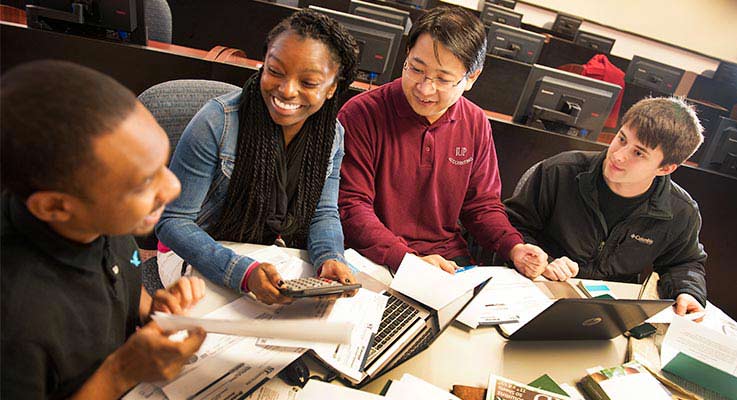 Four accounting students work on a tax project