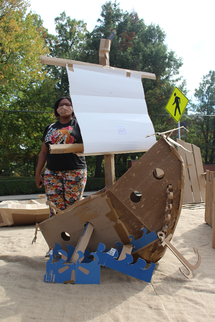 Cherisse Oliva Jones with a pirate ship sculpture
