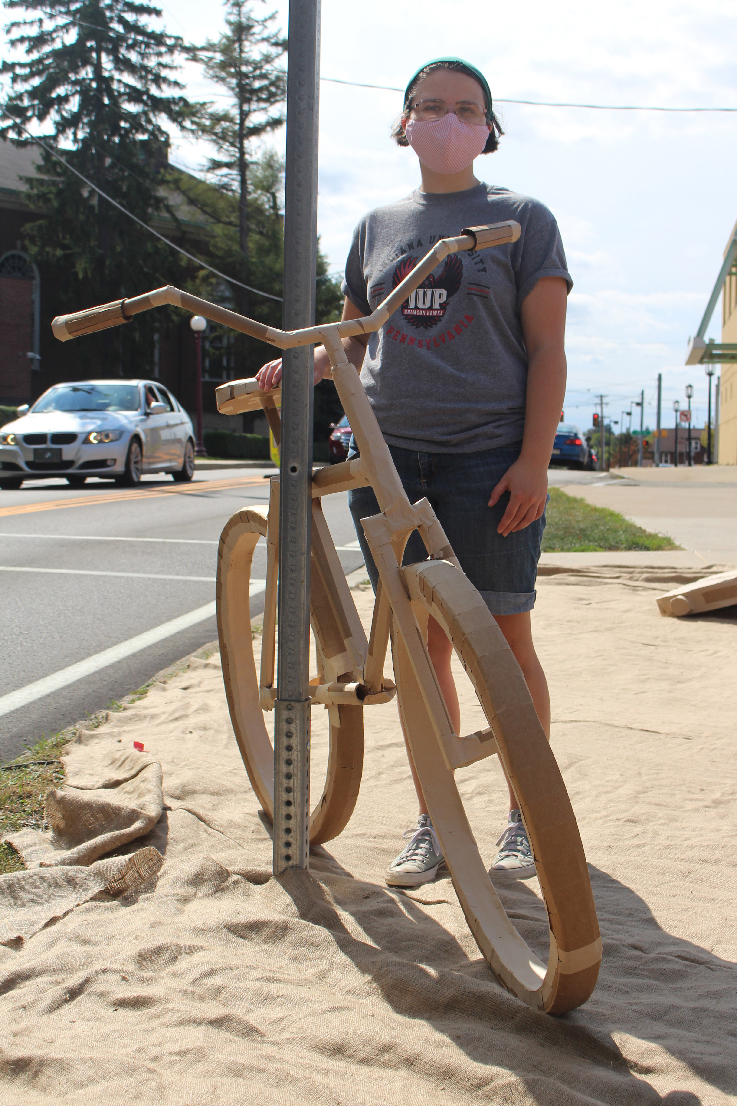 Julianna Shaffer with a bicycle sculpture