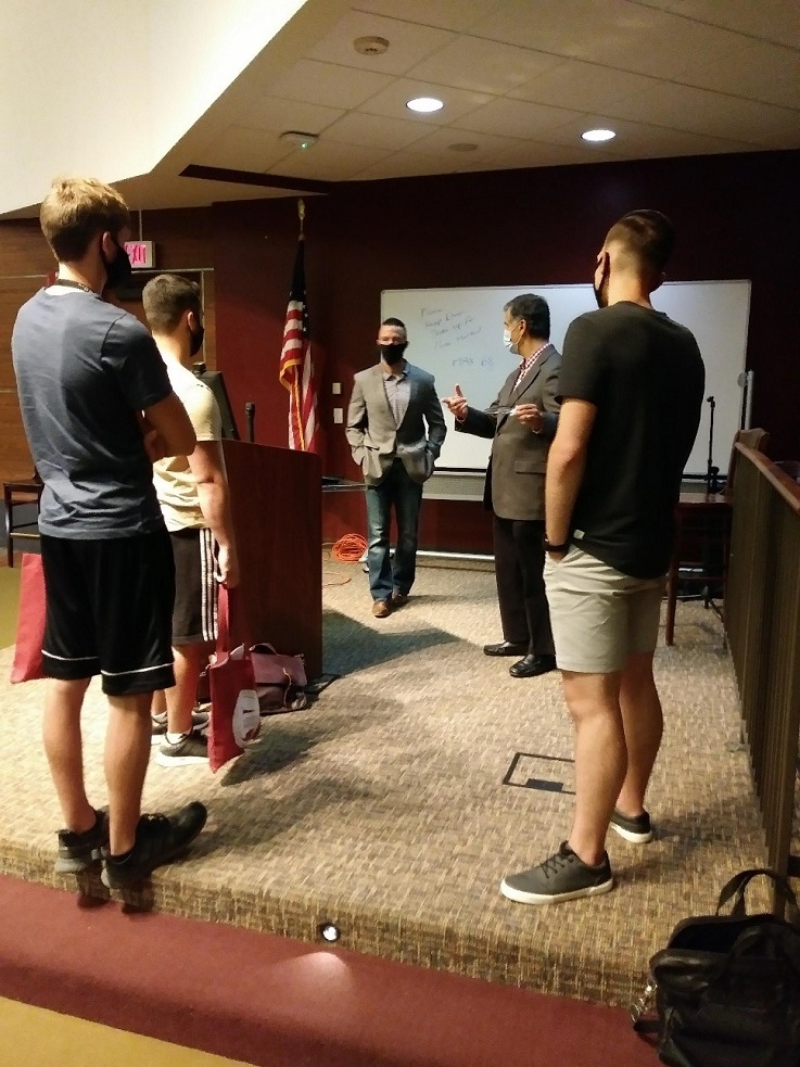 Dr. Ramesh Soni, Department Chairperson of Marketing, and Dr. Joseph Rosendale, faculty member, practice social distancing while leading a small group discussion following the departmental meeting.