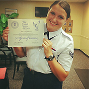 Caleigh Henry holds up a certificate