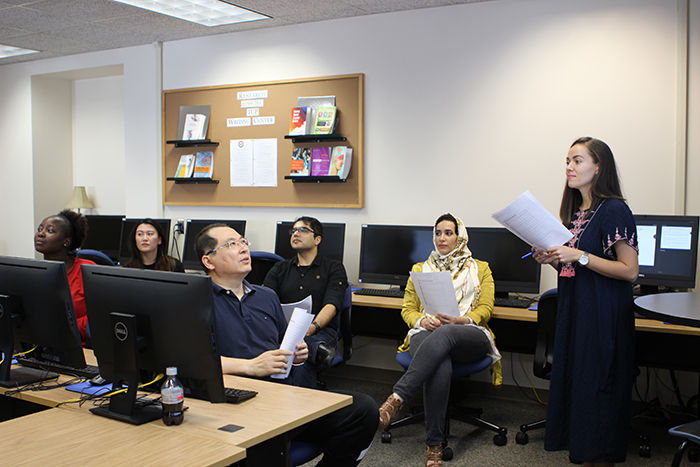 6 students in a group discussing a document