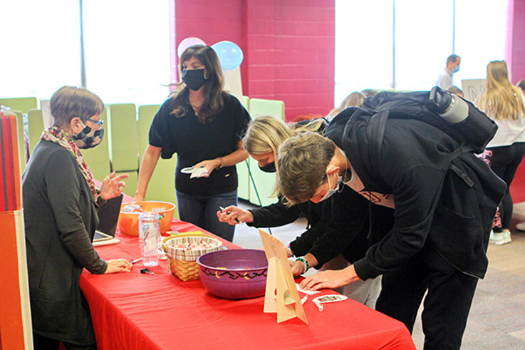 Students fill out a form at a table